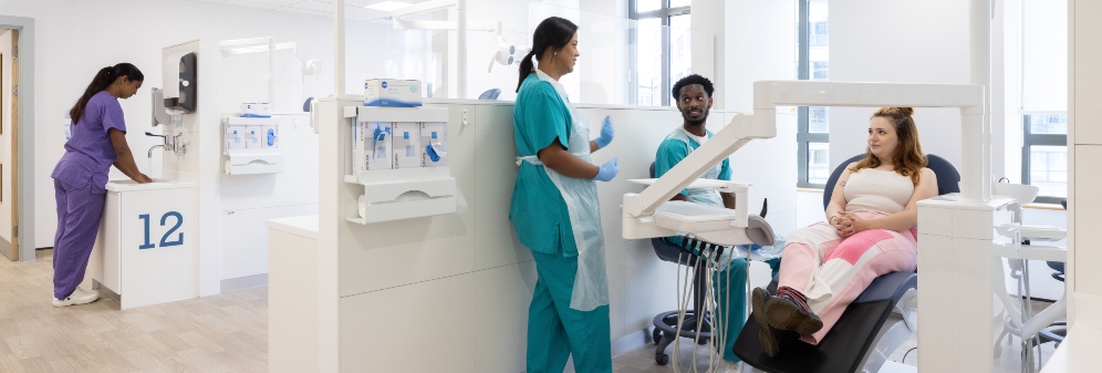 Two students talking to a patient on clinic at Avon Street
